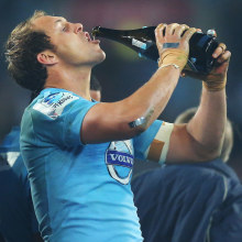 Stephen Hoiles of the Waratahs drinks champagne after winning the 2014 Super Rugby title.