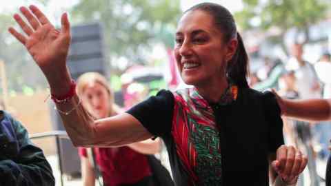 Claudia Sheinbaum waves as she holds a campaign rally in Mexico City