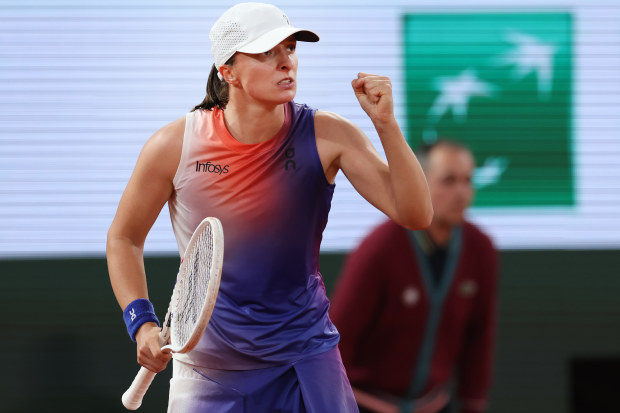 Iga Swiatek of Poland celebrates a point over Naomi Osaka of Japan.