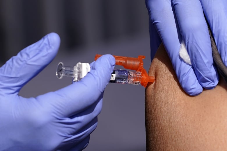 A person receives a needle