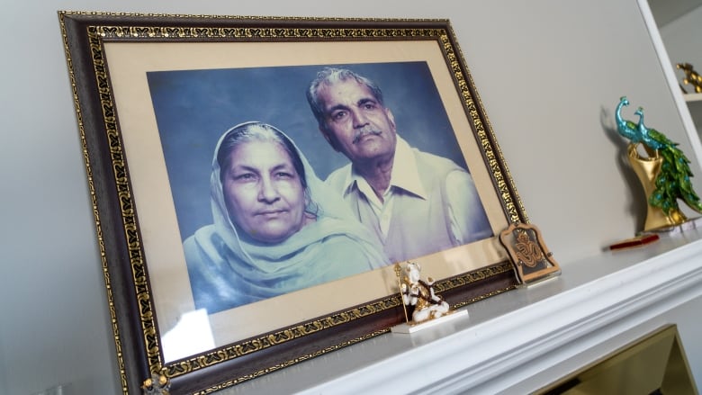 An old photo of Vivek's grandparents is pictured in a frame on a mantelpiece. 