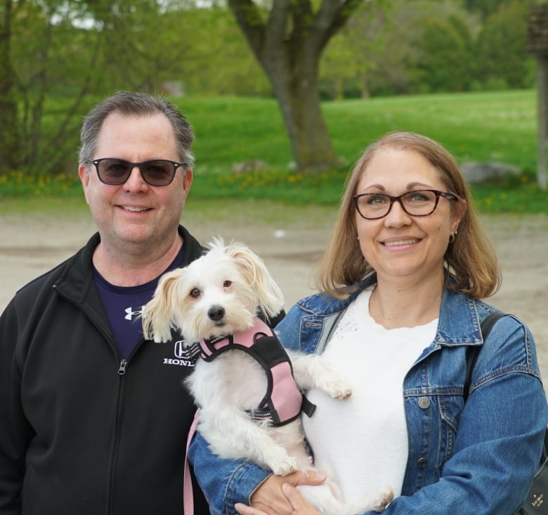 Photo of a couple and their dog.