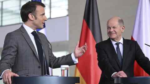 President Emmanuel Macron, left, at a press conference with Chancellor Olaf Scholz