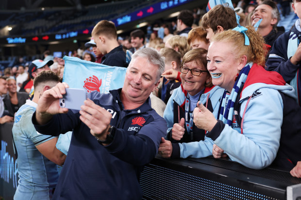 Waratahs coach Darren Coleman interacts with fans.