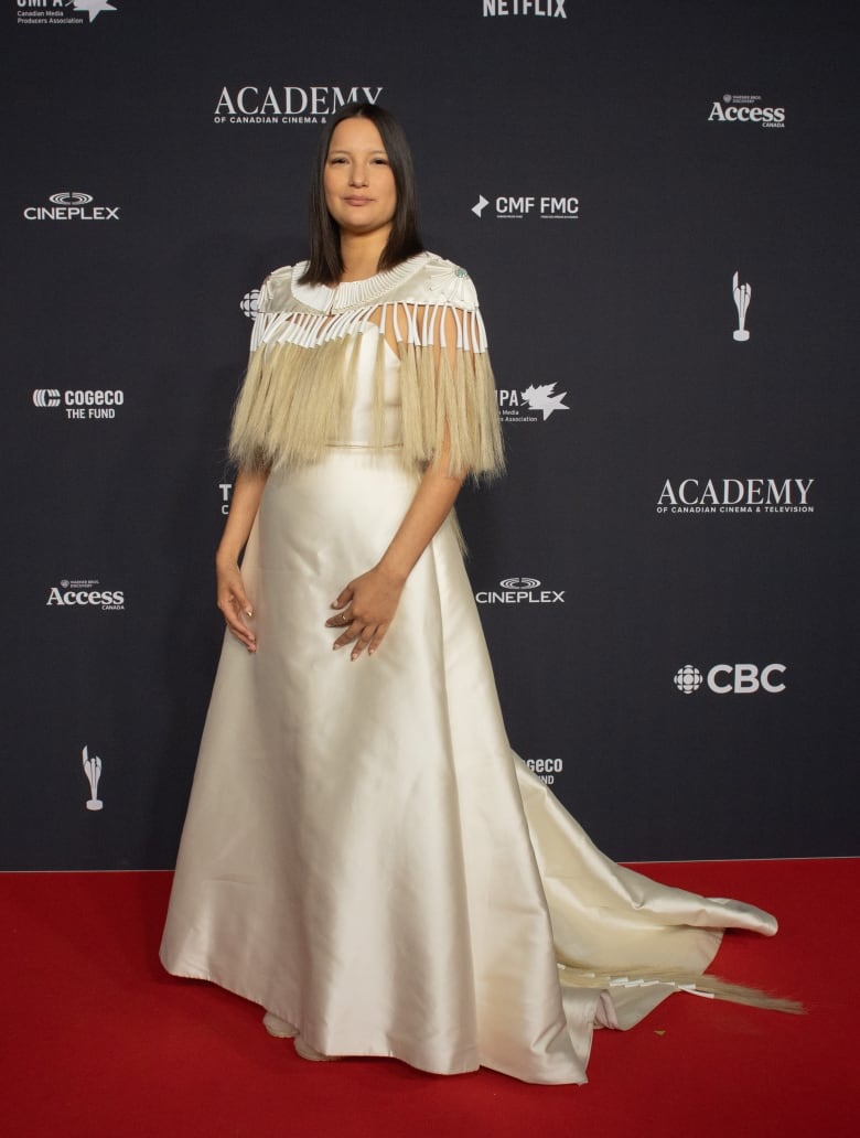 Darla Contois on the 2024 Canadian Screen Awards red carpet in a cream-coloured satin dress.