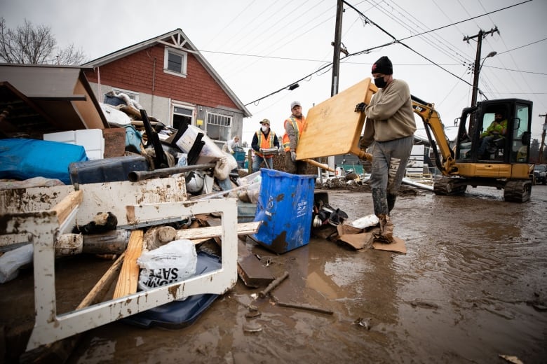 People clean up after flooding