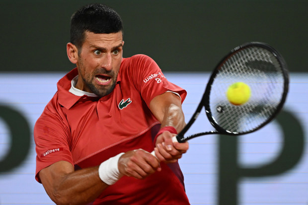 Novak Djokovic of Serbia plays a backhand against Lorenzo Musetti of Italy.