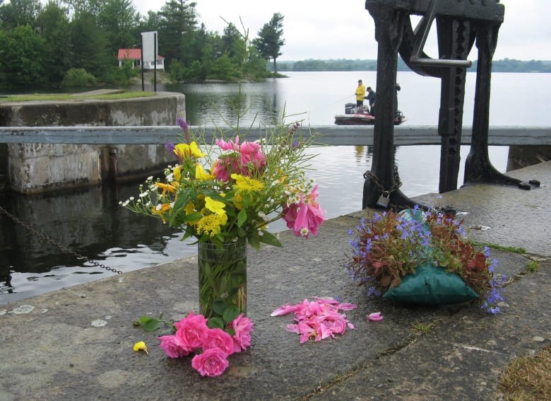 Flowers sit near the Kingston Mills locks on the Rideau Canal, at a memorial honouring four Montreal residents who died there in a car crash days earlier, in Kingston, Ontario on Thursday July 2, 2009.