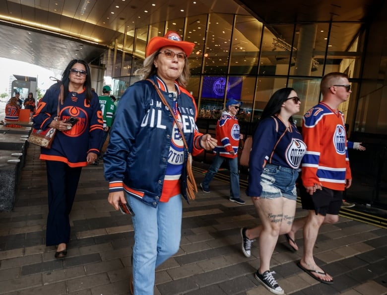 Oilers fans walking near the entrance of Rogers Place.