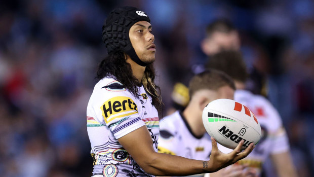 Jarome Luai spins the ball during warmup.