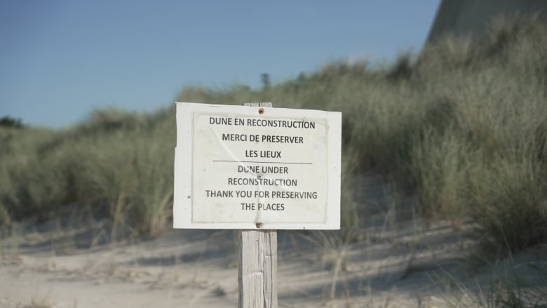 A sign on a beach