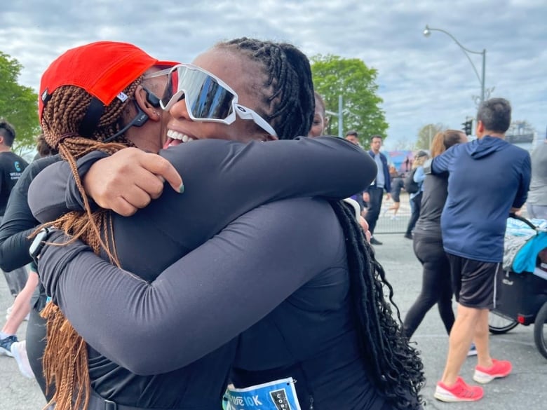 Two women in sporting gear embrace