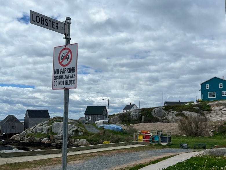 A civic road sign marks the entrance to Lobster Lane in Peggys Cove, Nova Scotia. 