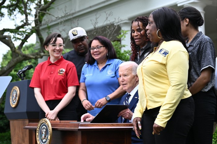 President Joe Biden signs an order last month to increase tariffs on Chinese electric vehicles