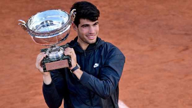 Carlos Alcaraz of Spain celebrates with the winners trophy after victory in the Men's Singles Final match between Alexander Zverev of Germany and Carlos Alcaraz of Spain on Day 15 of the 2024 French Open at Roland Garros on June 09, 2024 in Paris, France. (Photo by Lionel Hahn/Getty Images)