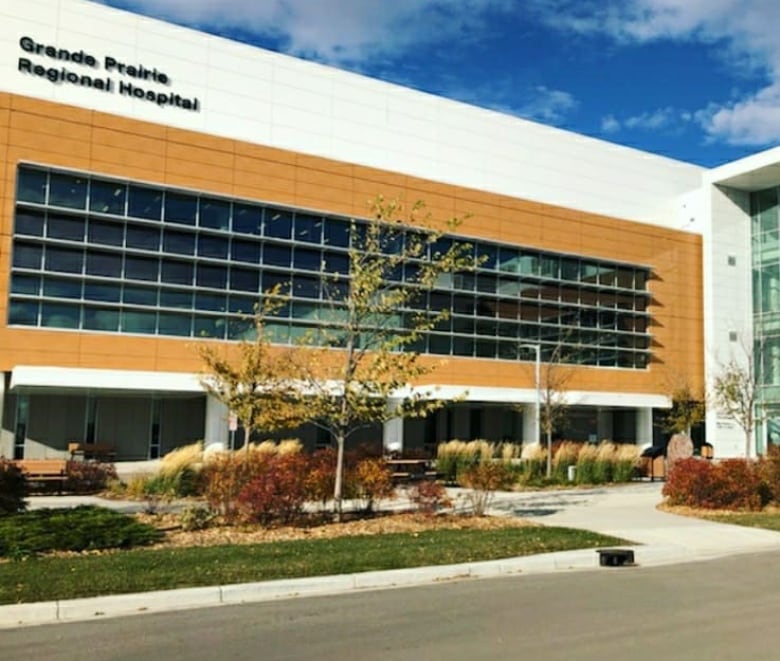 A large building. The words "Grande Prairie Regional Hospital" are in black letters near the top.