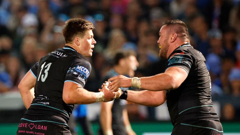 Glasgow Warriors' Scottish centre Huw Jones (R) celebrates with tighthead Zander Fagerson (R) after scoring a try against The Bulls (Pretoria)