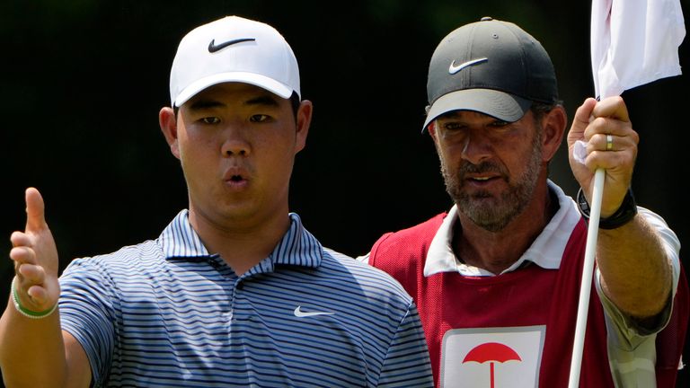 Tom Kim, of South Korea, lines up a putt on the 11th hole during the final round of the Travelers Championship golf tournament at TPC River Highlands, Sunday, June 23, 2024, in Cromwell, Conn. (AP Photo/Seth Wenig)