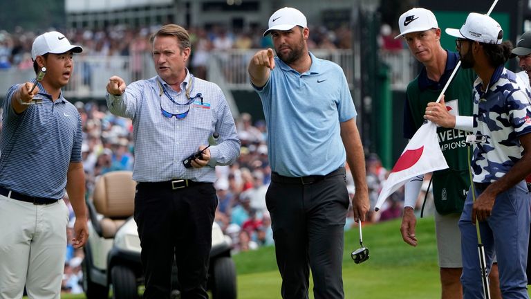 Golfers Tom Kim, left, of South Korea, Scottie Scheffler, center, and Akshay Bhatia, right, talk to an official after protesters ran onto the 18th green during the final round of the Travelers Championship golf tournament at TPC River Highlands, Sunday, June 23, 2024, in Cromwell, Conn. (AP Photo/Seth Wenig)