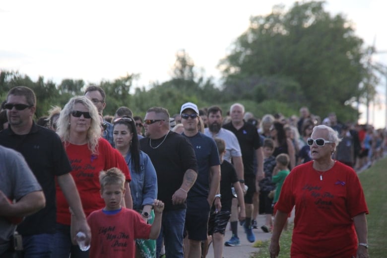 People walk the track in the dusk