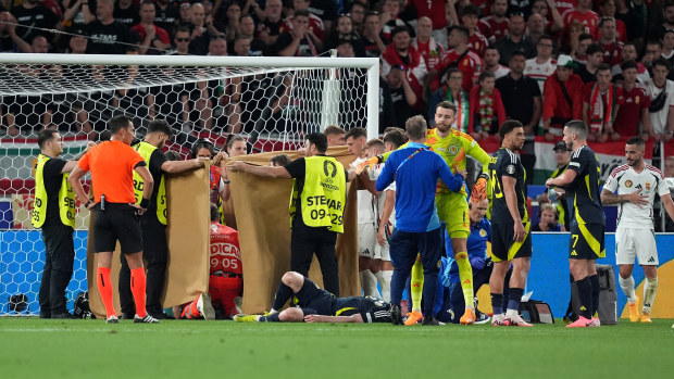 Hungary's Barnabas Varga receives treatment following a collision during the Euros.