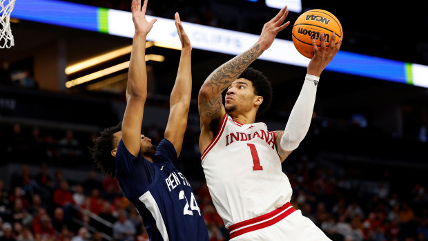 Kel'el Ware of the Indiana Hoosiers goes up for a shot against Zach Hicks of the Penn State Nittany Lions.