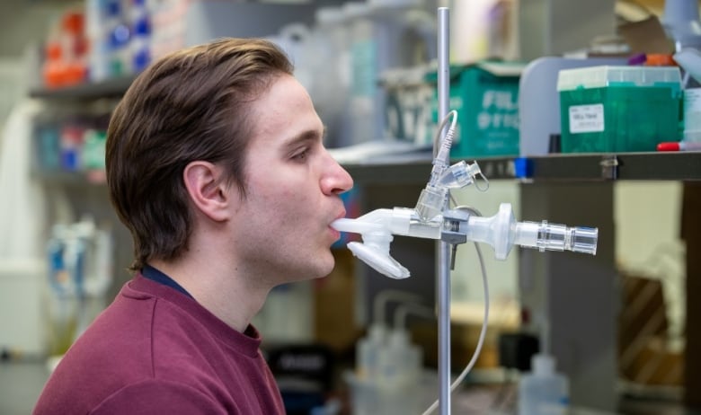 Man demonstrates use of the inhaled vaccine system at a lab.