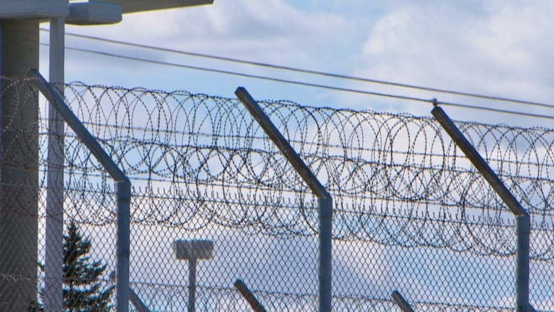 Chain link fencing and barbed wire.