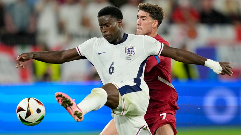 England's Marc Guehi, challenges for the ball with Serbia's Dusan Vlahovic during a Group C match between Serbia and England at the Euro 2024 soccer tournament in Gelsenkirchen, Germany, Sunday, June 16, 2024. (AP Photo/Andreea Alexandru)