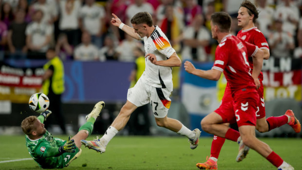 (L-R) Kasper Schmeichel of Denmark, Florian Wirtz of Germany, Joachim Andersen of Denmark compete for the ball. Euros 2024