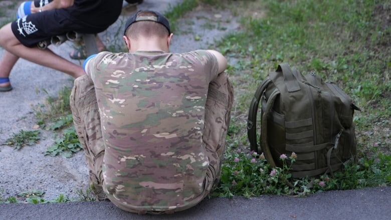 A wounded Ukrainian soldier rests on his way from the frontline.