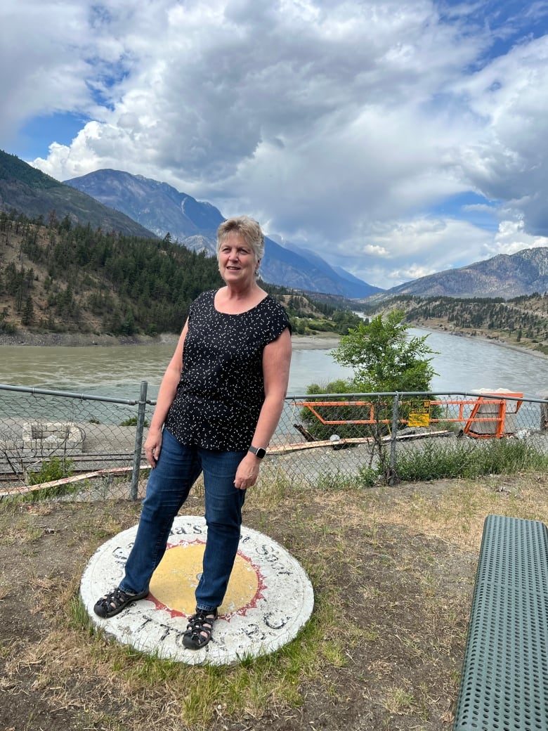A woman stands on a circular hot spot in Lytton
