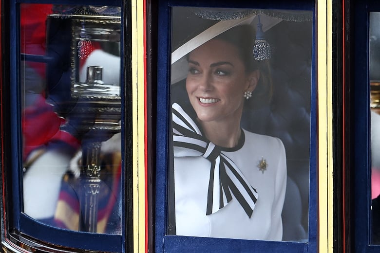 A  woman smiles in a carriage