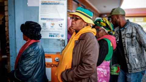 Voters queue to cast their ballots in South Africa