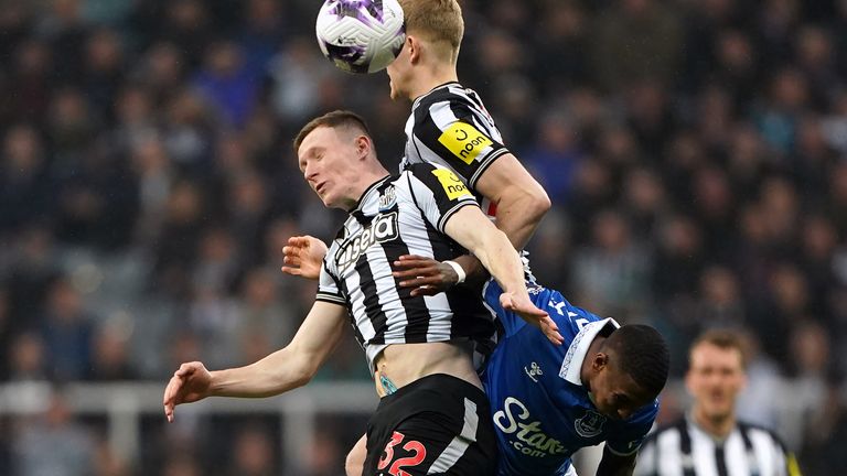 Elliot Anderson, Lewis Hall and Ashley Young challenge for a header