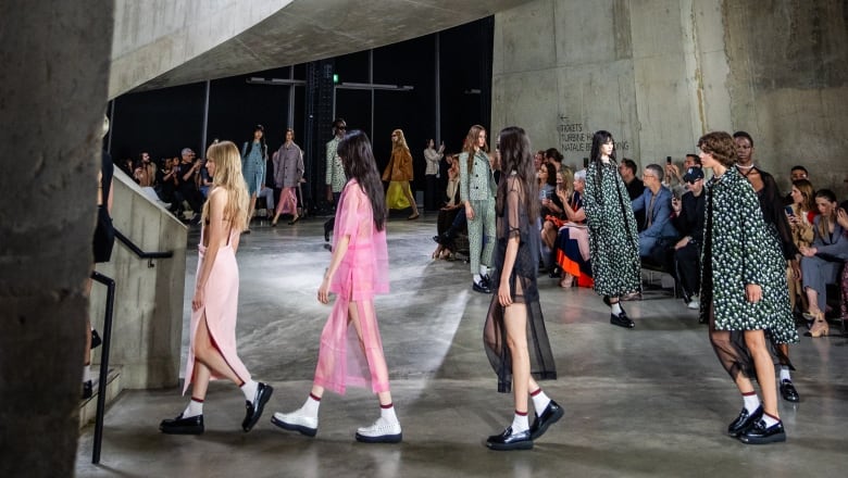 Women walk in a circle at a fashion  show