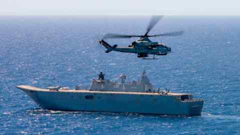 An AH-1Z Viper helicopter conducts flight operations with Royal Australian Navy Canberra-class vessel HMAS Canberra during Exercise Rim of the Pacific 2022