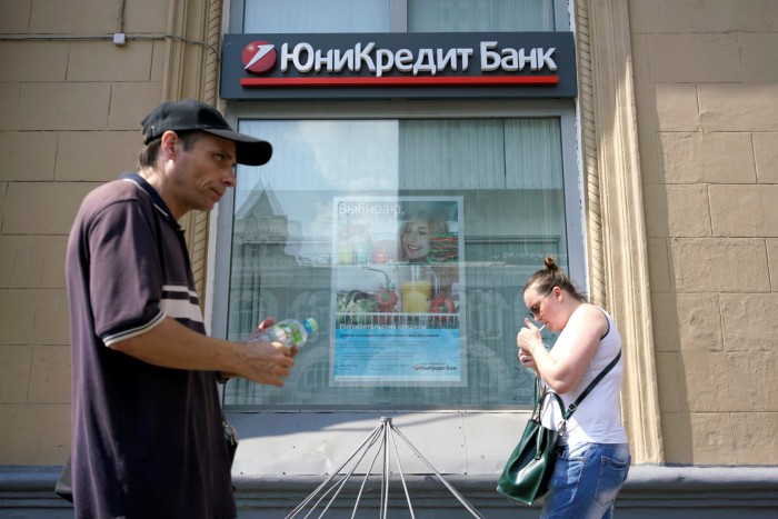 People walk past a UniCredit bank in Moscow 