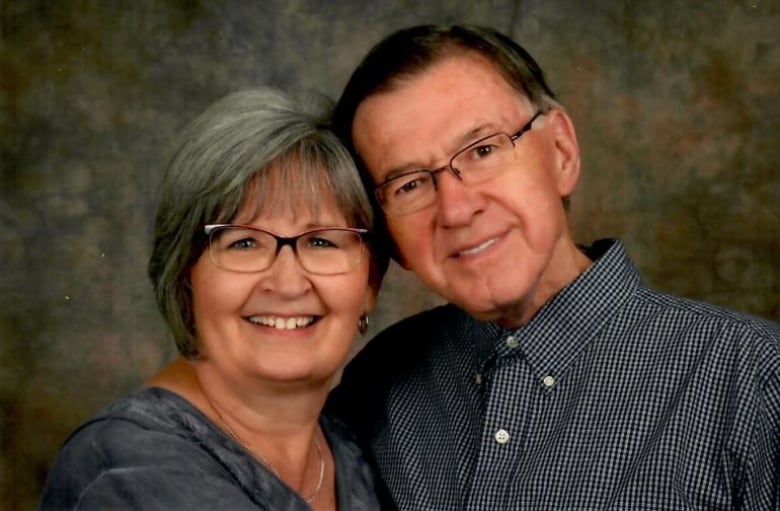 A woman and man pose for a photo. 