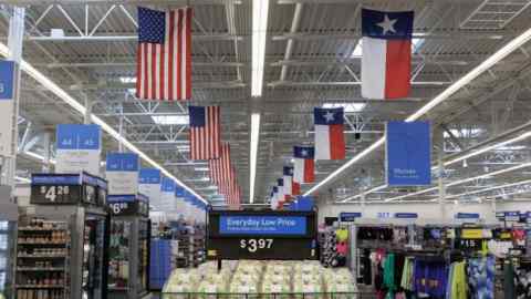 American and Texas state flags hang inside a Walmart store in Grand Prairie, Texas