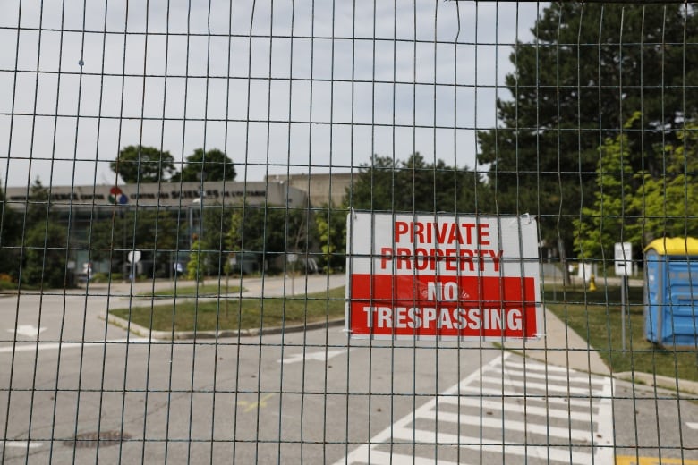 A fence with a no trespassing sign.