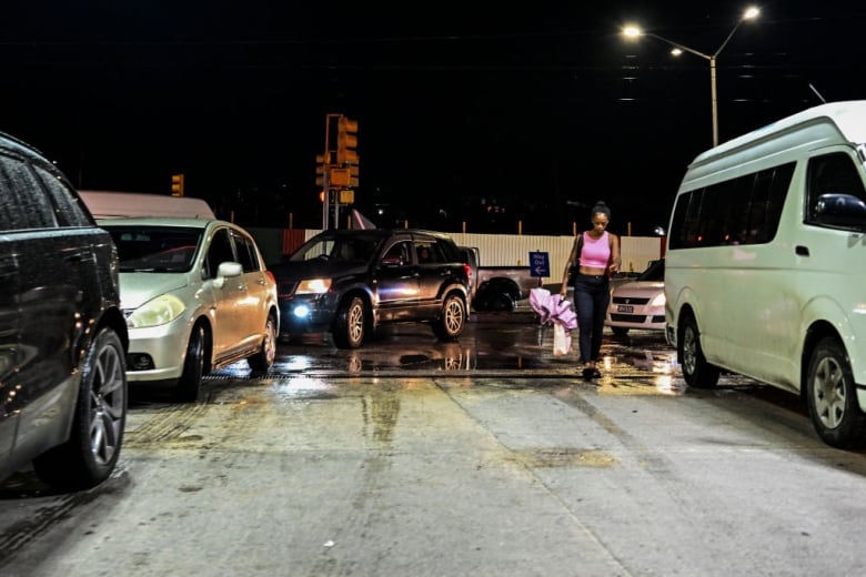 Cars line up at a gas station.