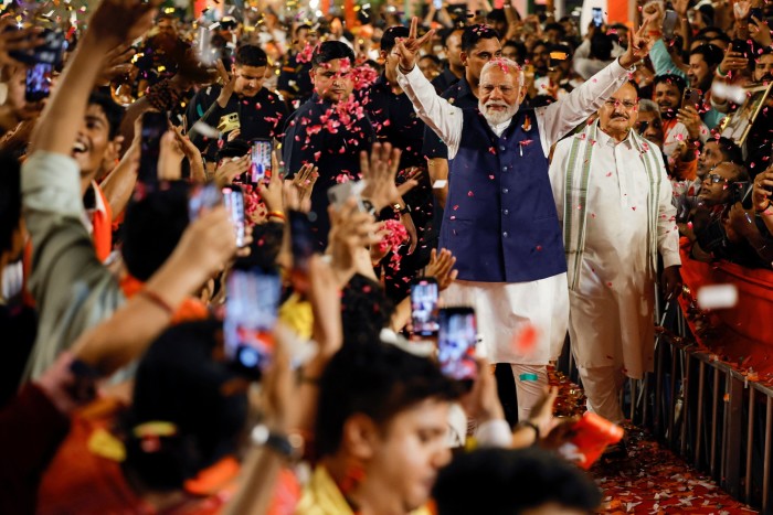 Modi waving as supporters throw confetti at BJP headquarters