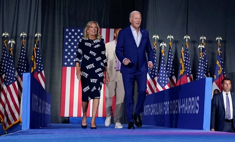 Biden and wife walking onto a stage