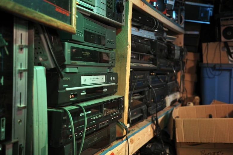 A shelf shows well over a dozen tape players. 