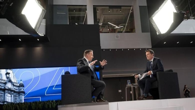 Two men on elevated set speaking