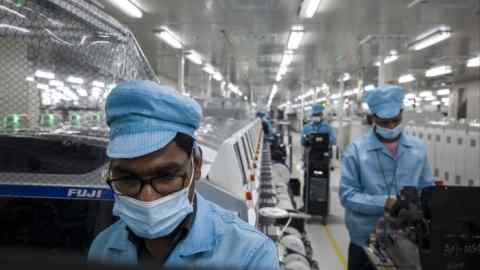 Workers at the Chinese smartphone maker Realme factory in Greater Noida, India