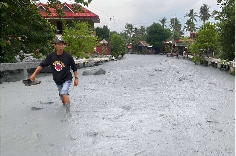 Volcanic mud and debris washes through a village in the central Philippines after Mount Kanlaon werupted a day earlier