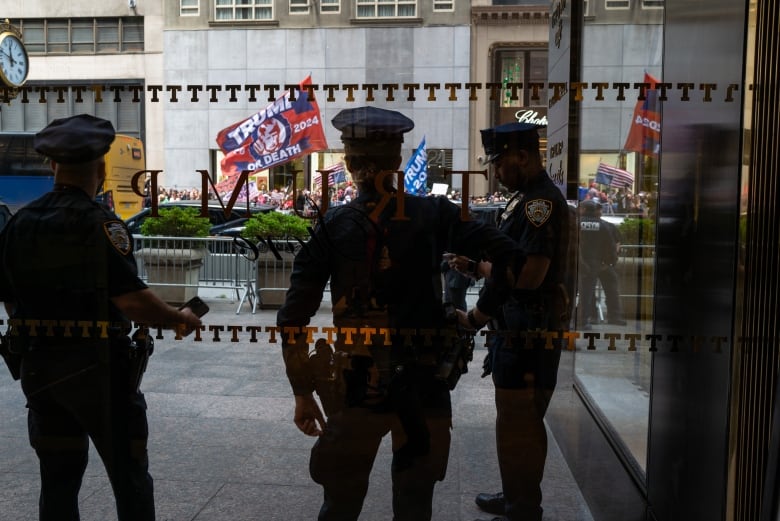 Police watch protesters outside Trump Tower in New York City.