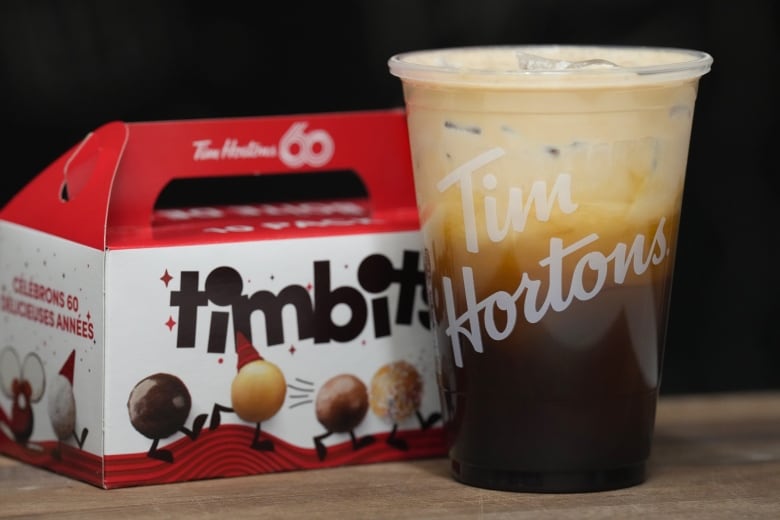 An ice coffee and a package of Tim Hortons timbits are shown.